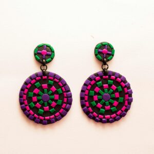 Vibrant round earrings with green, pink, and purple mosaic design on a minimalist white background.