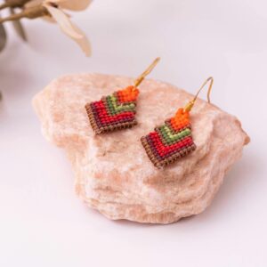 Handcrafted beaded chevron earrings beautifully placed on a light stone surface.