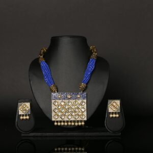 Luxury blue beaded necklace and earrings set displayed on a black background, showcasing elegance.