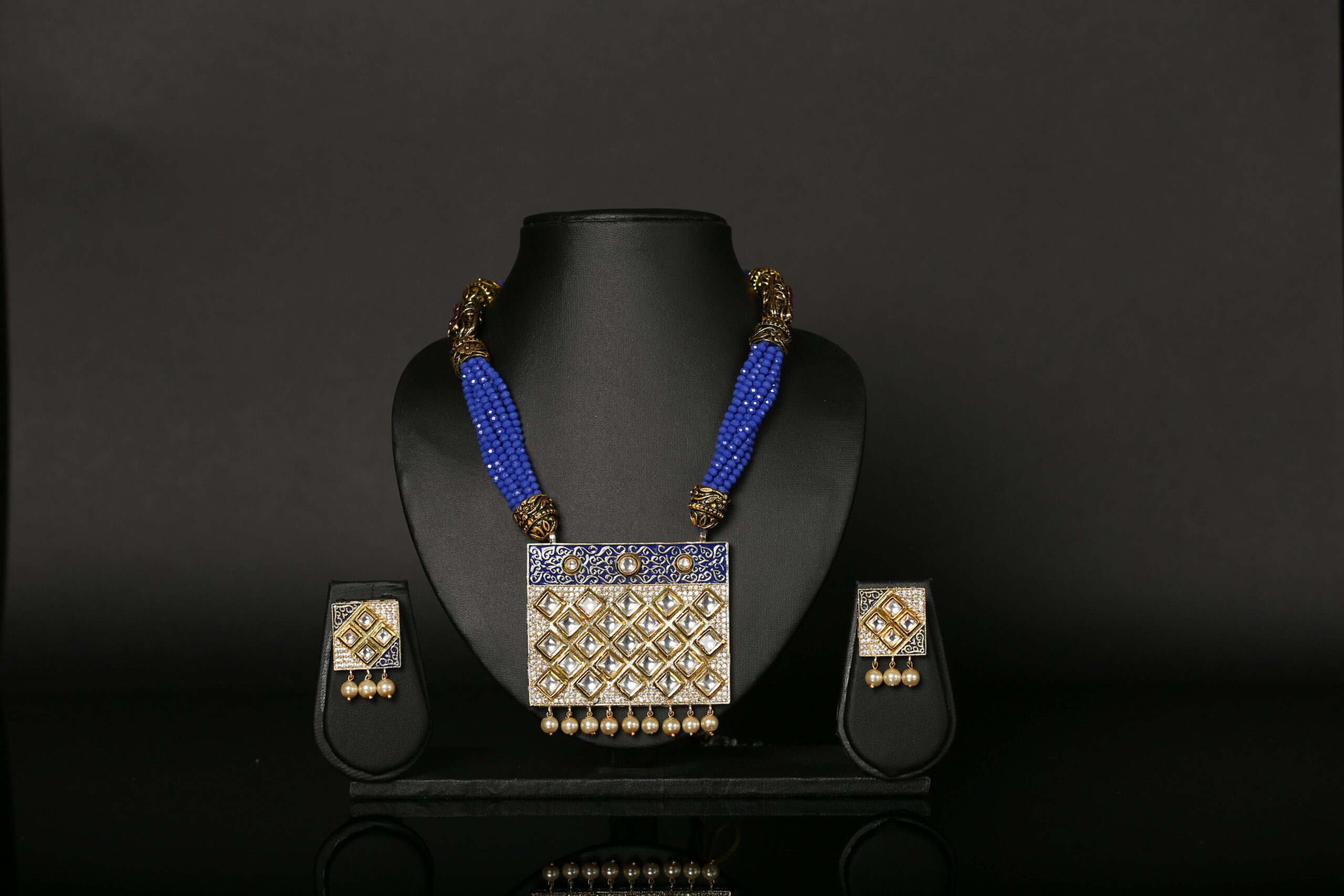 pexels photo 4295010 4295010 Luxury blue beaded necklace and earrings set displayed on a black background, showcasing elegance.